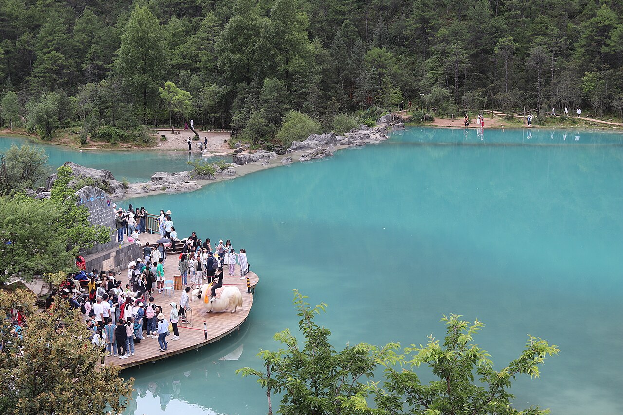 Erhai Lake with wooded hills and a village on the shore near Shuanglang