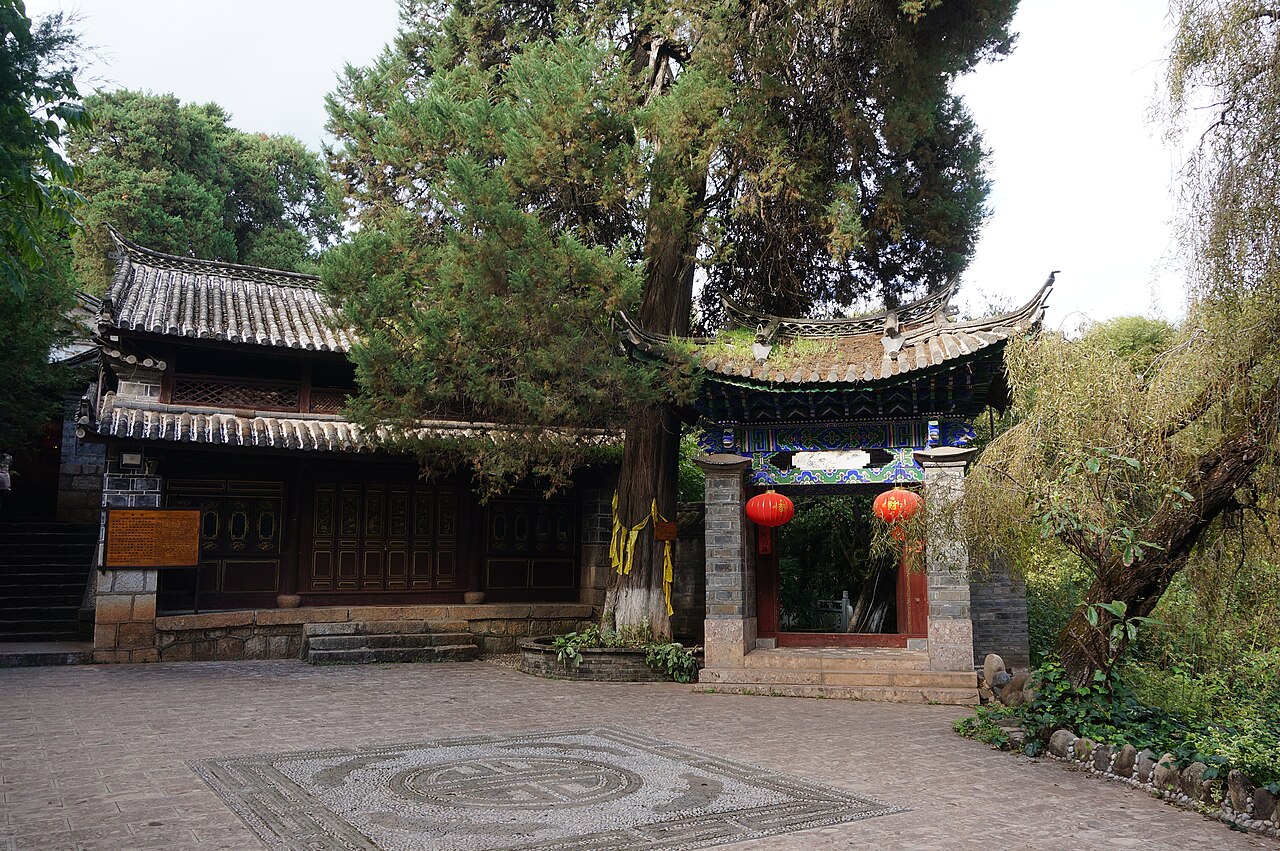 A timber courtyard building among trees at Shuhe old town