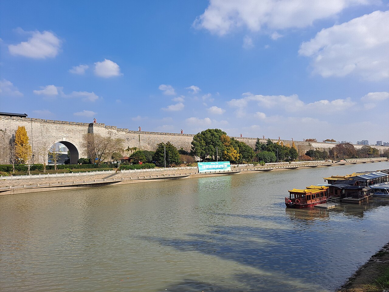 The Ming city wall and moat at Zhonghua Gate, Nanjing, with a boat passing