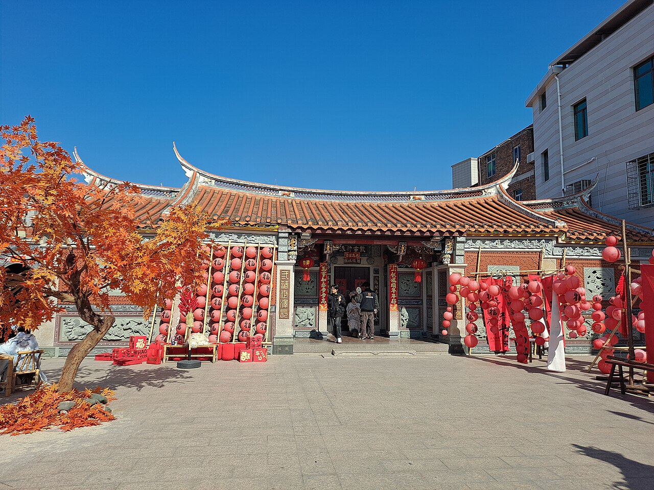 A temple in Xunpu village hung with red lanterns and festival decorations