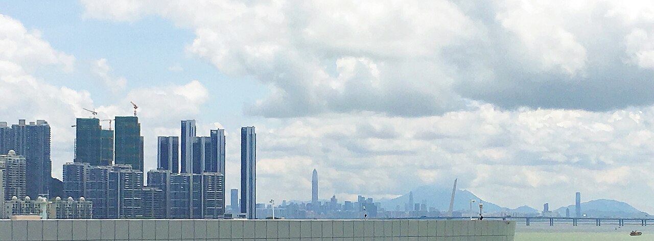 The Shenzhen skyline seen across the water from the Shekou cruise terminal, with towers rising behind the harbour.