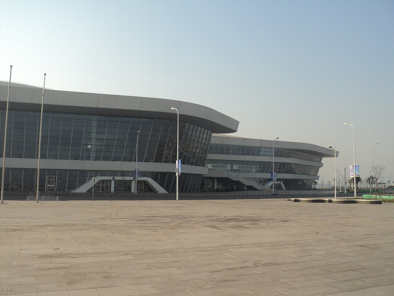The curved white terminal building of the Tianjin International Cruise Home Port seen from the quay.