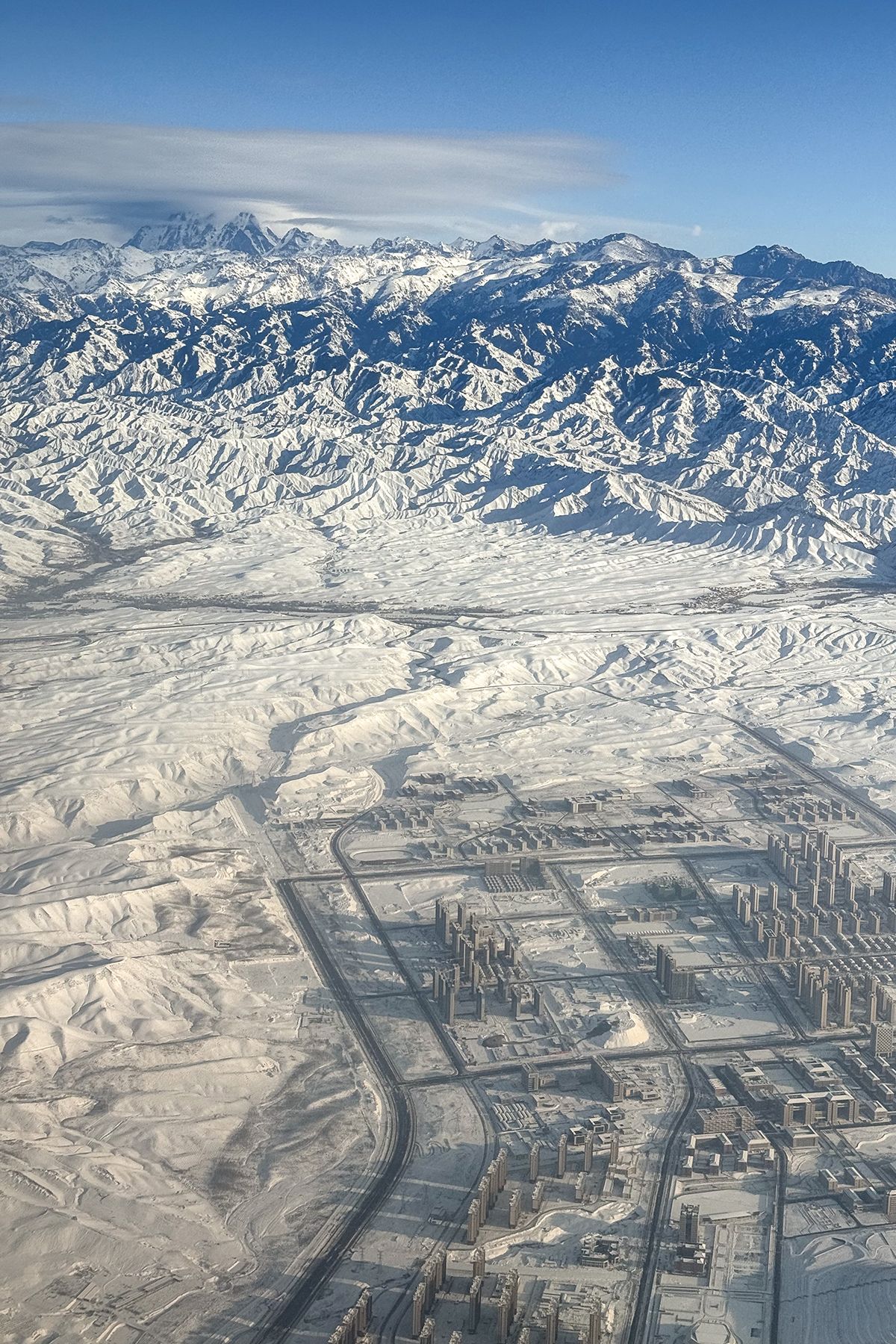 The snow-covered ridges of Bogda Peak from the air