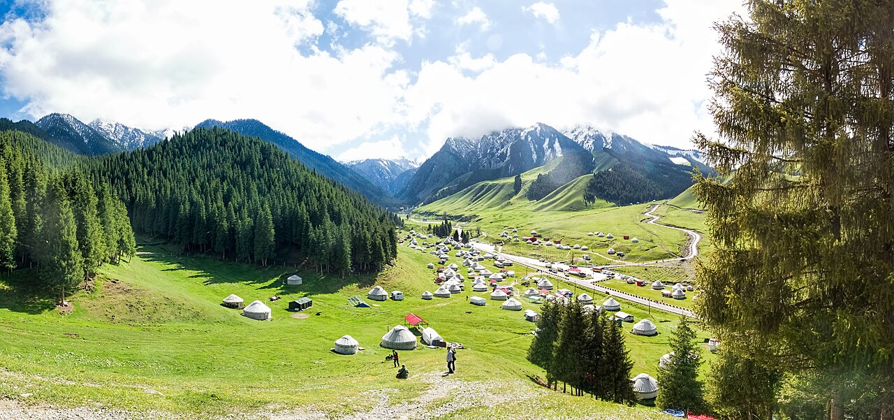 Yurts scattered across the green Nanshan pasture valley