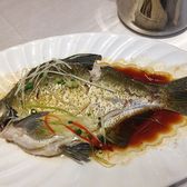A whole steamed Wuchang bream under shredded ginger and spring onion in dark soy sauce