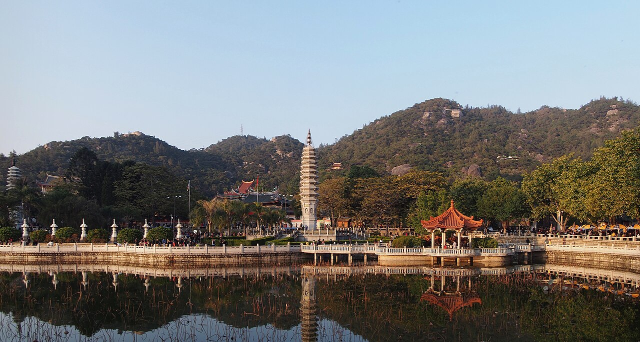 The lotus pond and pagoda in front of Nanputuo Temple, with the hills behind