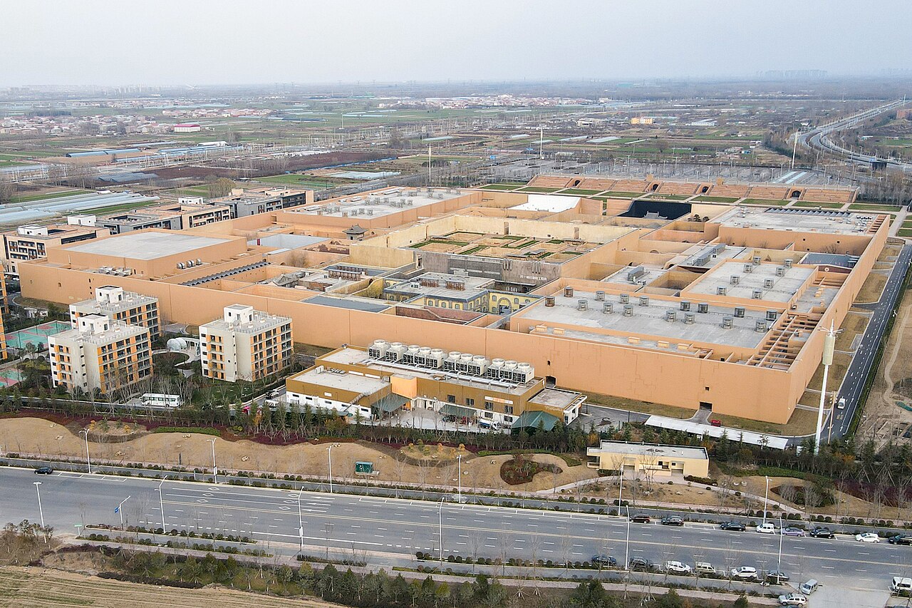 Aerial view of the vast walled courtyards of the Unique Henan theater complex beside its wheat field.