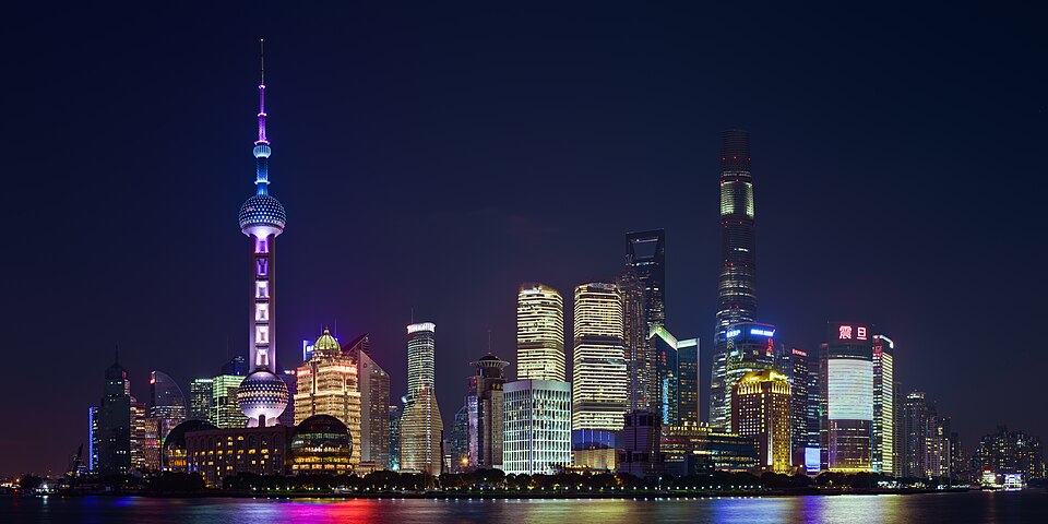 The Pudong skyline lit at night across the river