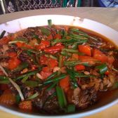 A plate of Yangshuo beer fish cooked with peppers and tomato
