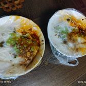Two bowls of jiang mian tiao noodles under their bean sauce
