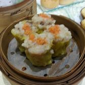 A steamer of dumplings topped with crab roe