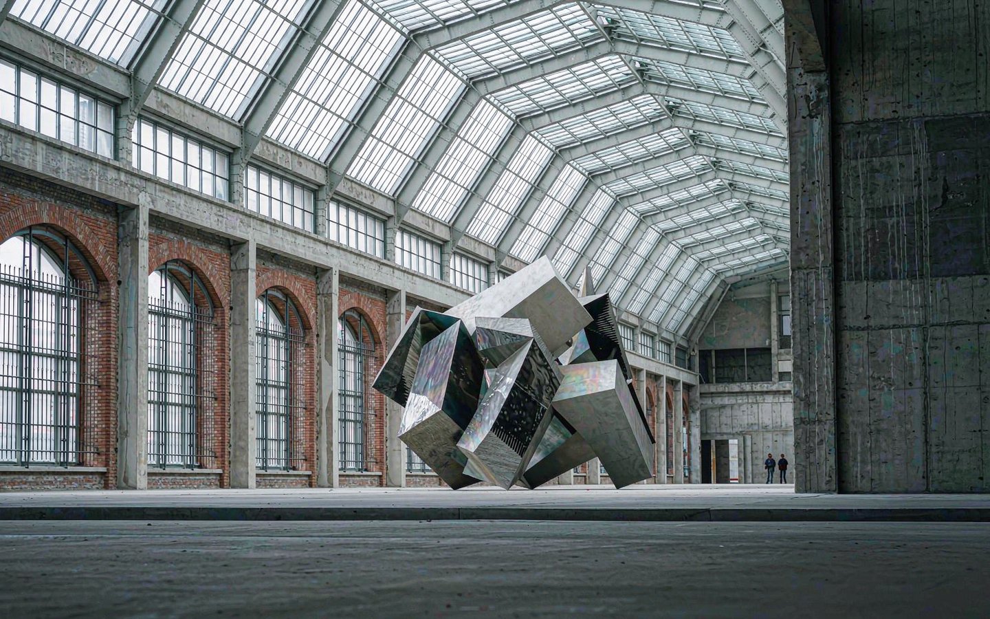 Bauhaus factory hall with sawtooth skylights and contemporary art