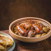 A bowl of luzhu huoshao, offal and flatbread in a dark broth