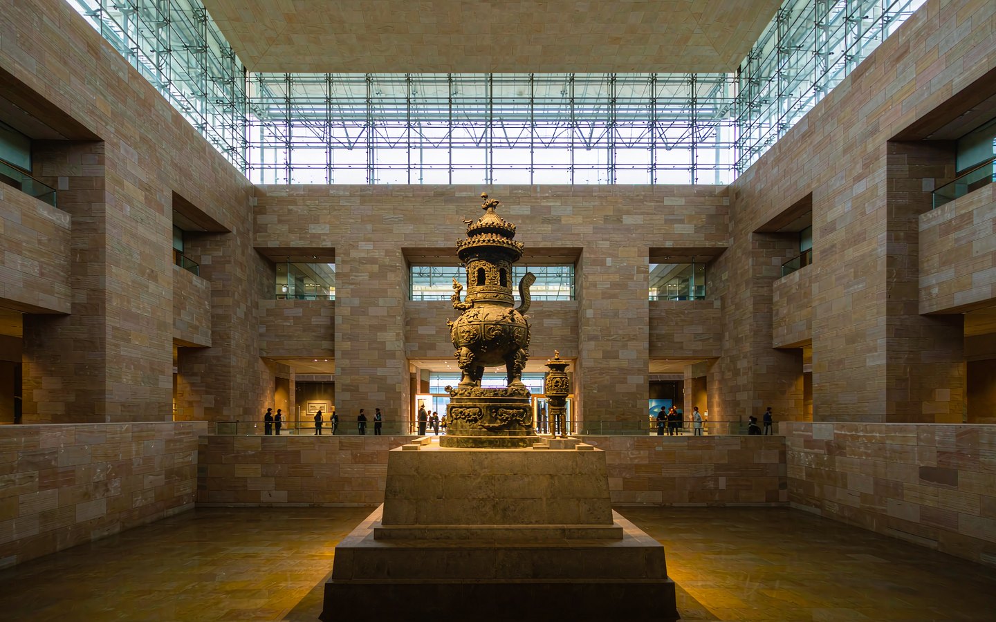 Vast museum atrium with a giant bronze ritual vessel on display