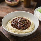 A bowl of zhajiangmian with the sauce and shredded vegetables on top