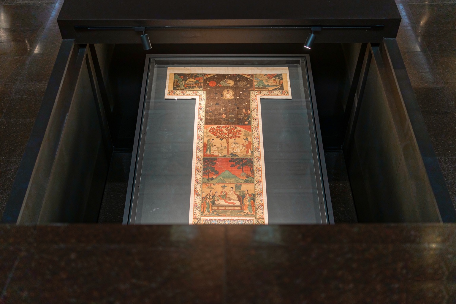 The painting on silk depicts the heaven (upper part), the human realm (middle part), and the netherworld (bottom part).