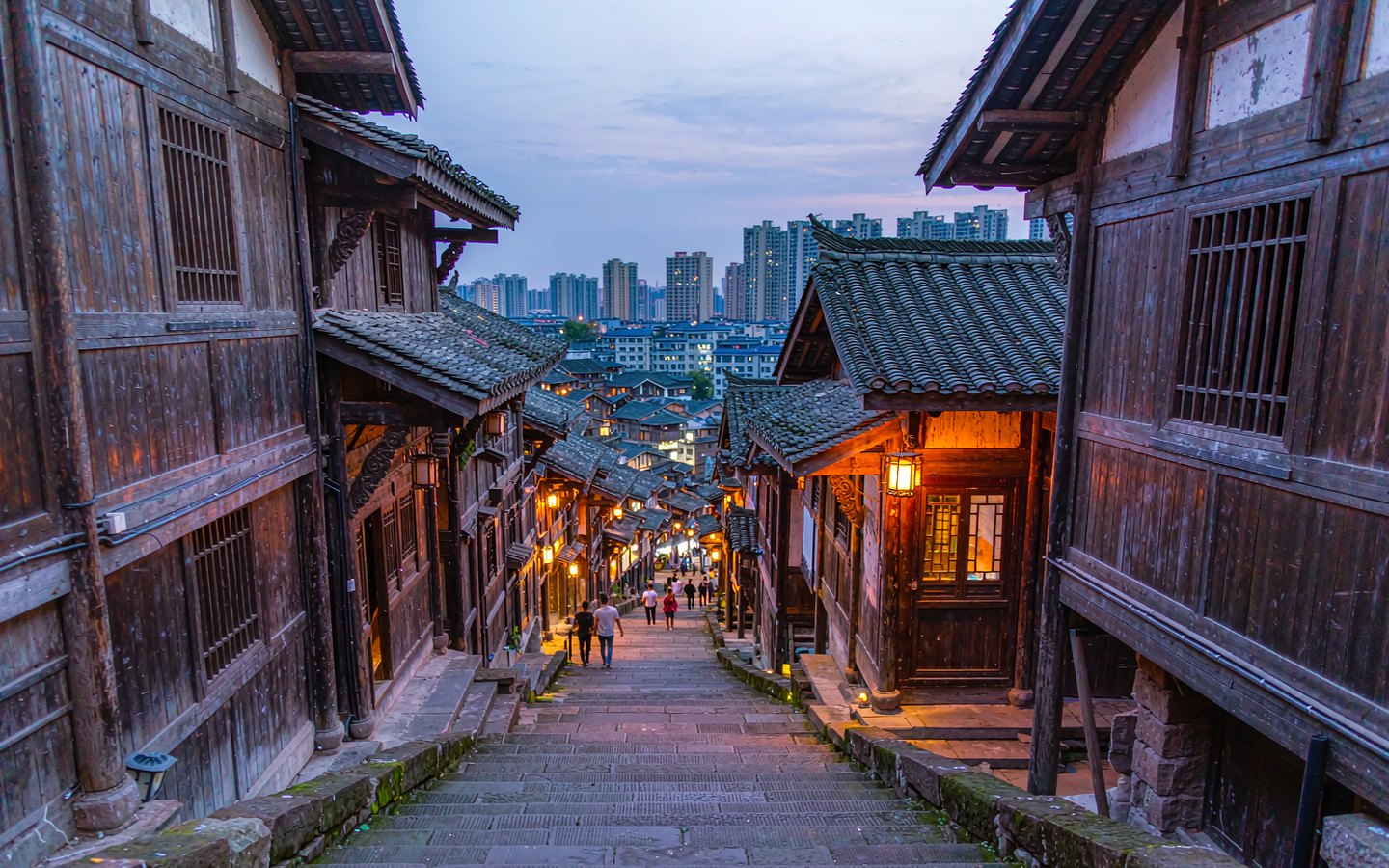 Long stone stairway descending through stacked old-style houses