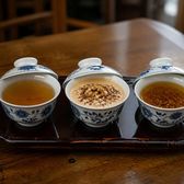 Three small lidded tea cups on a tray, one clear, one with walnut, one spiced