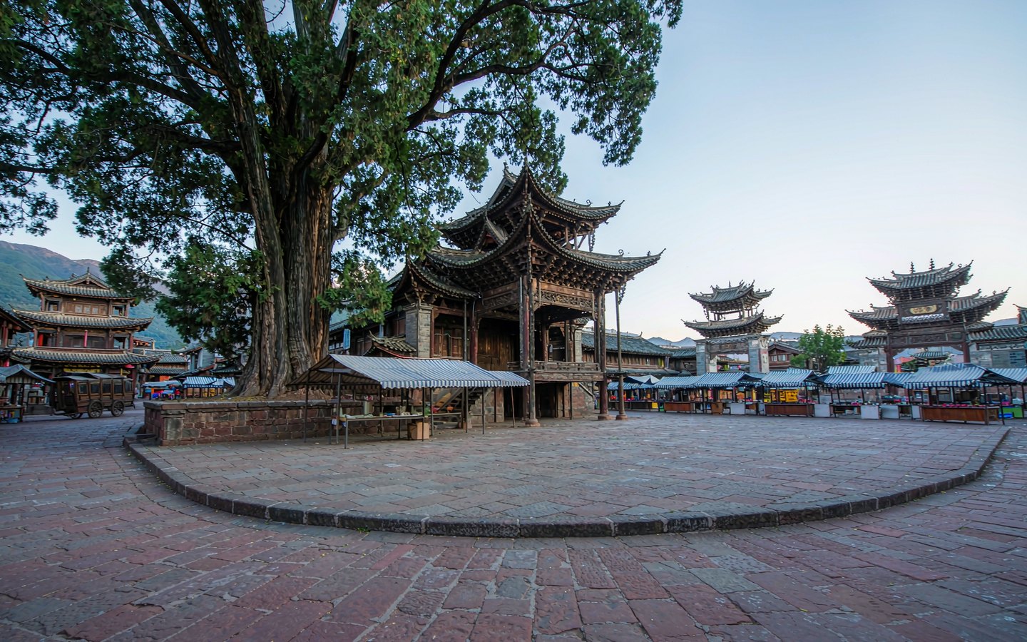 Red-sandstone market square with an old theatre stage and locust tree