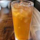 A tall glass of chilled amber apricot-skin water with ice