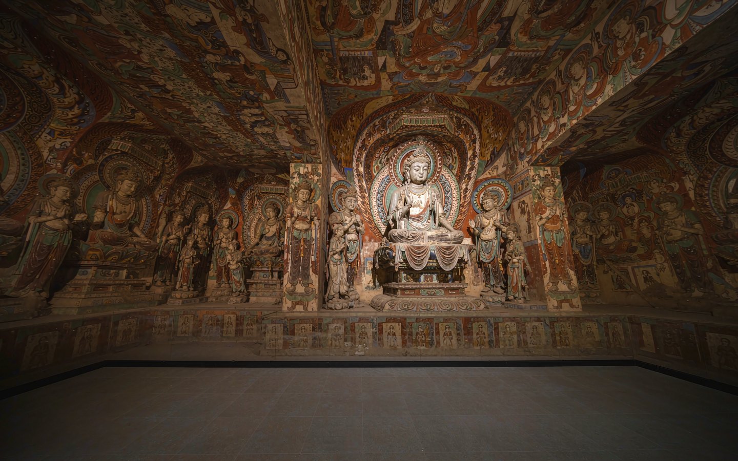 Replica painted cave interior with Buddha figures in a museum