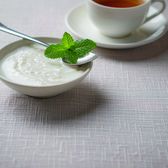 A bowl of double-skin milk pudding with a sprig of mint