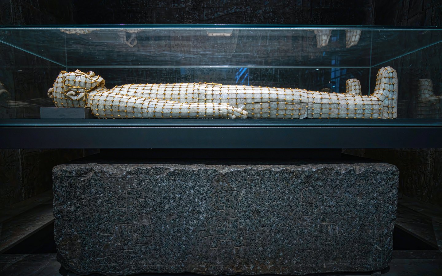 Stone tomb chamber with a silk-and-jade burial suit on display