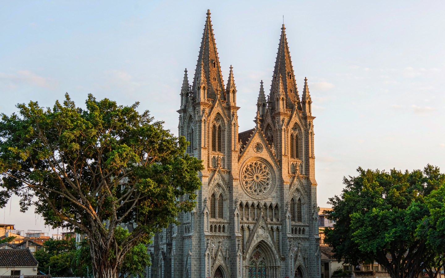 Twin granite spires of a Gothic cathedral above old-town rooftops