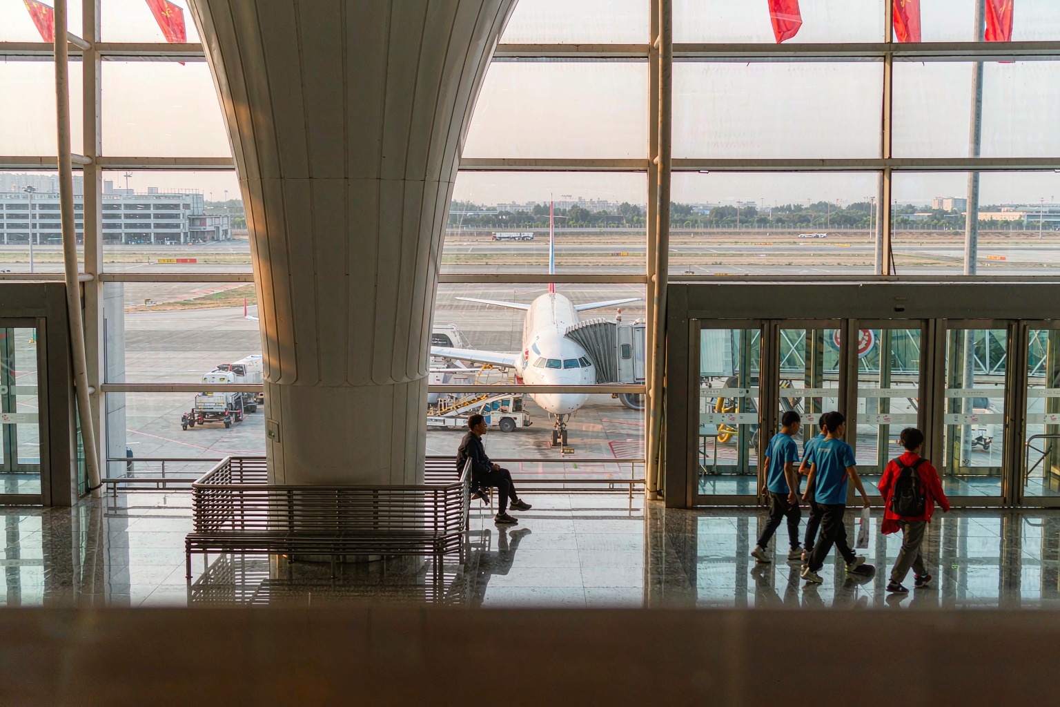 A passenger jet at the gate seen through an airport terminal window in China