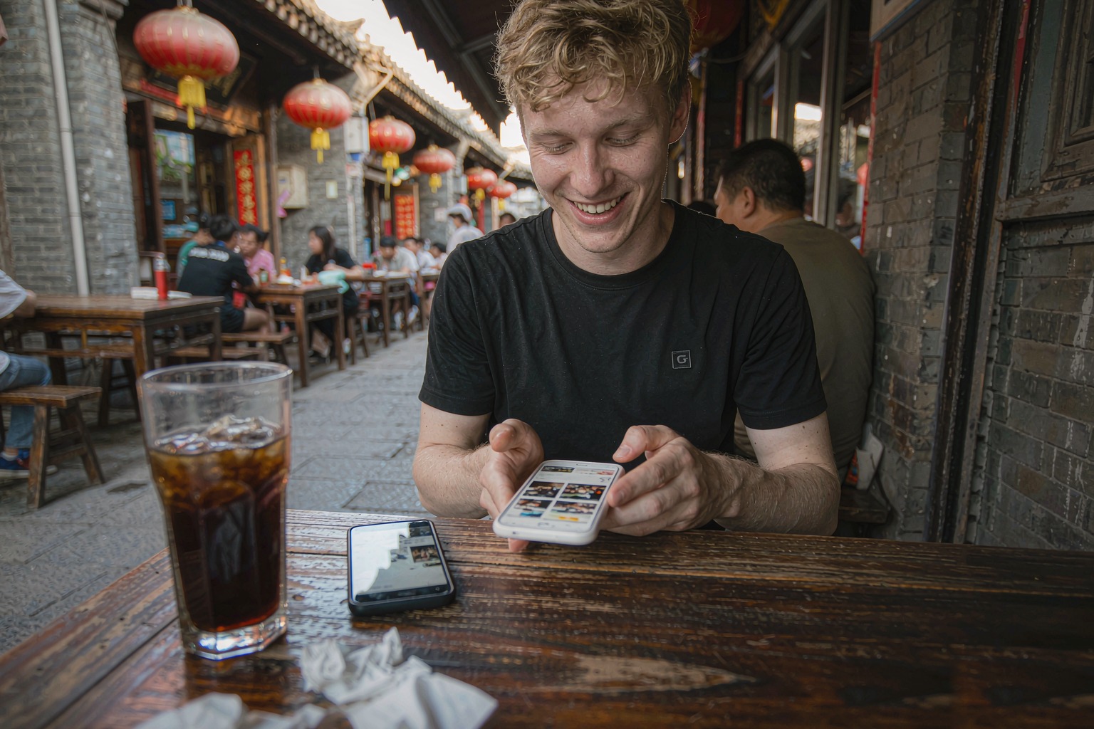 A foreign traveler in a Chinese old-town alley browsing a western social media feed on his phone