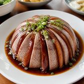 Slices of taro and braised pork belly stacked in a dome on a plate
