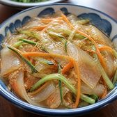 Wide translucent starch sheets tossed cold with shredded cucumber and carrot