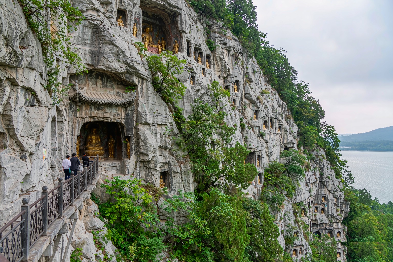 A stone walkway and cave shrine carved into the cliff face of the Western Hills above Dianchi Lake near Kunming