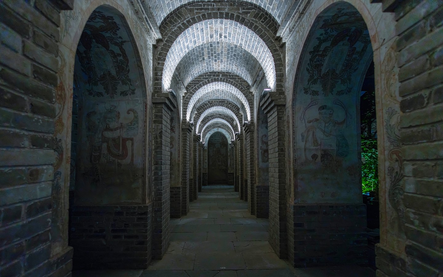 Stone tomb passage leading to a painted burial chamber