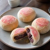 Round flaky pastries stamped with a peony pattern, one broken open