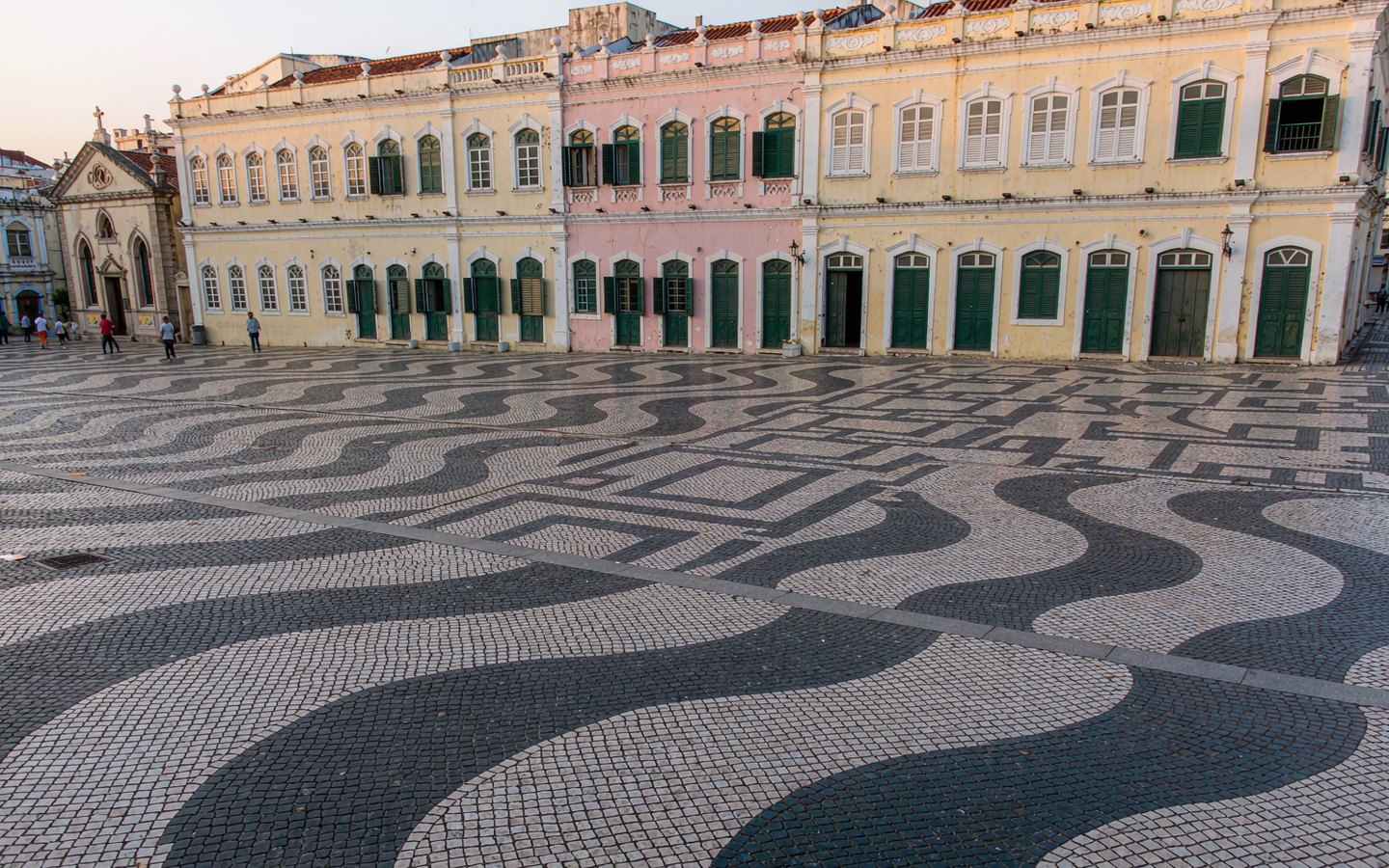 Pastel colonial facades around a cobbled Portuguese-style square