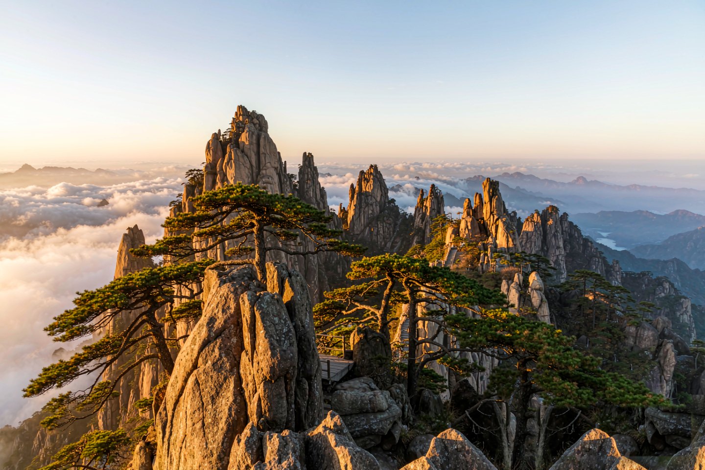 Granite peaks of Mount Lao rising above a sea of cloud at dawn