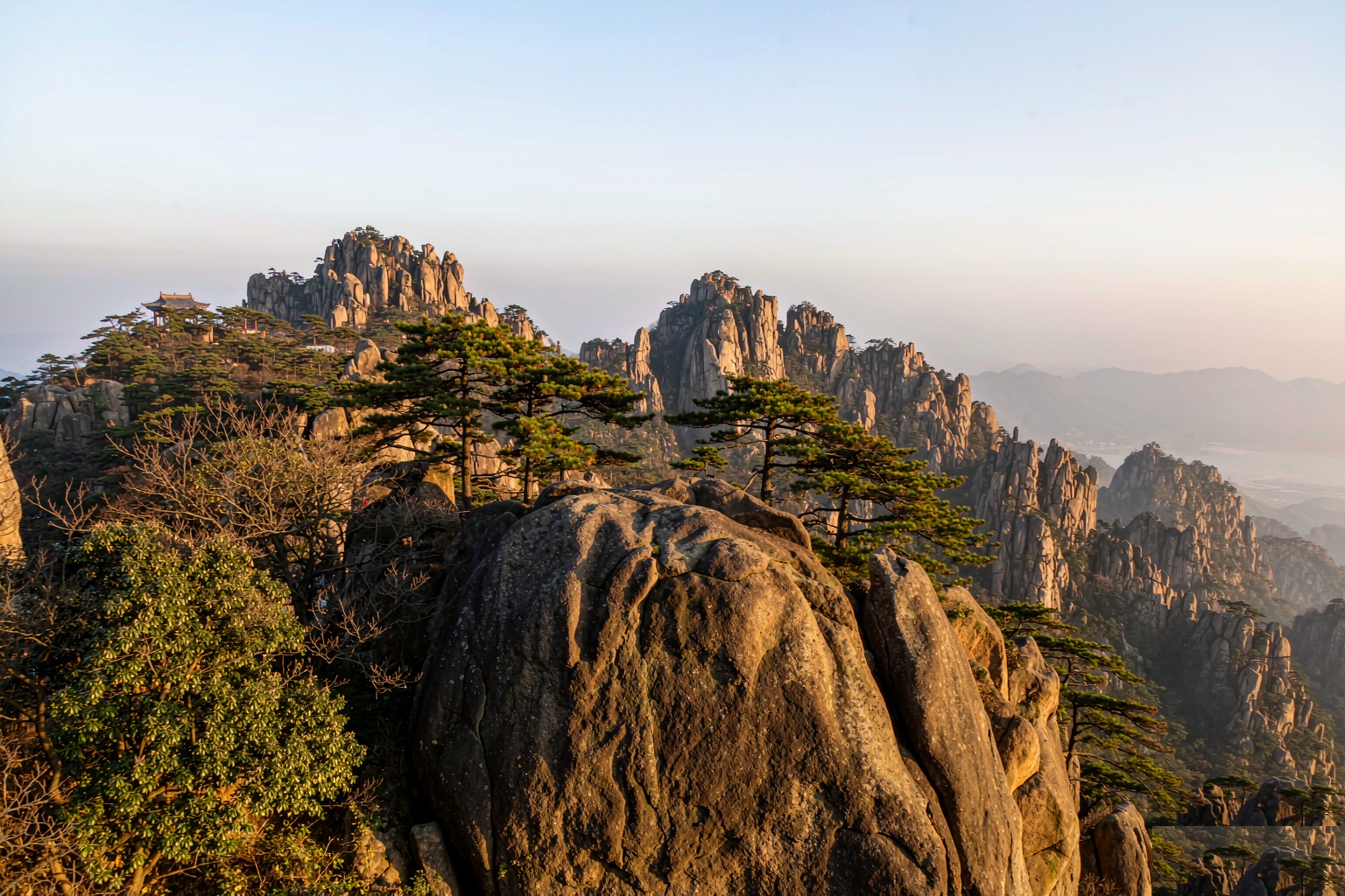 Mount Lao granite peaks rising above the sea near Qingdao, with mist on the higher slopes