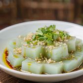 Translucent pale-green seaweed jelly cubes in a bowl, dressed with vinegar, garlic and coriander