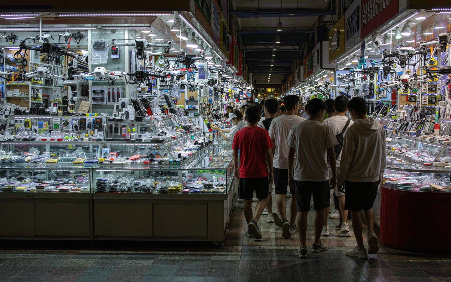 Corridors of electronics stalls glowing with screens and gadgets