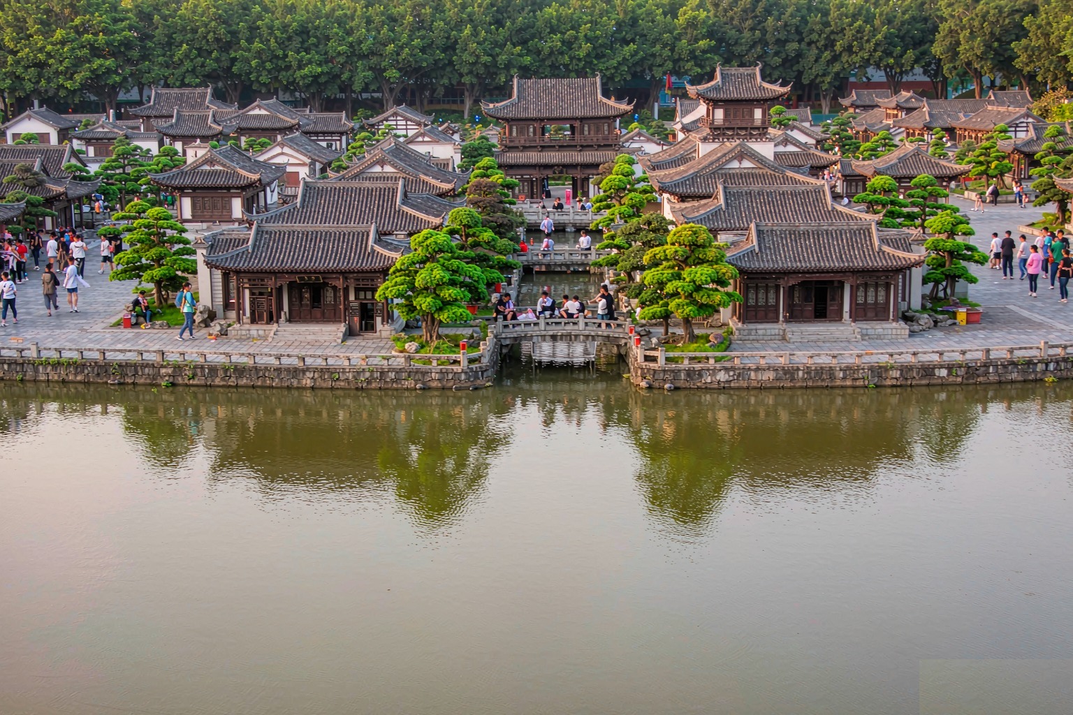 Traditional Chinese temple roofs and courtyard houses reflected in the lake at Splendid China Folk Village