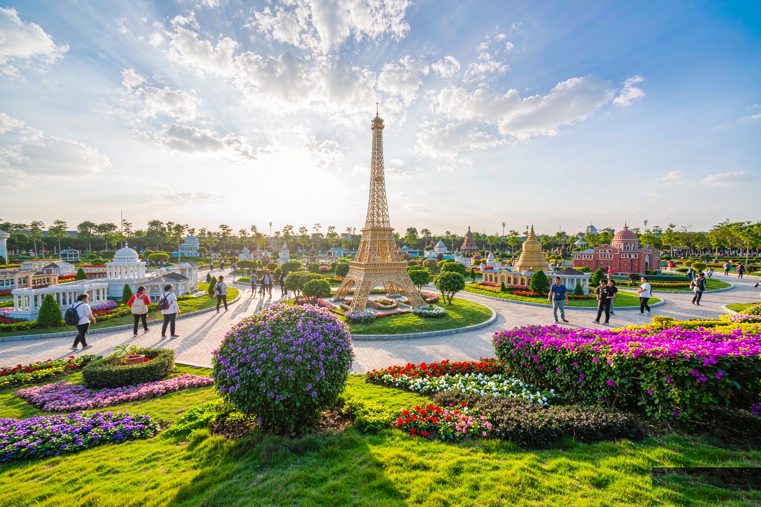 The scale replica Eiffel Tower rising above flowerbeds at the Window of the World theme park in Shenzhen