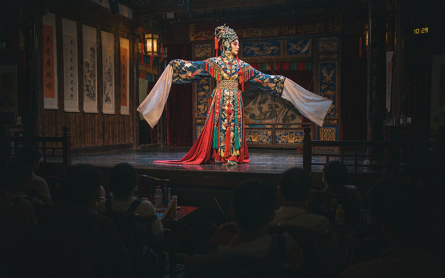 Kunqu performer in flowing water-sleeve costume on a small stage