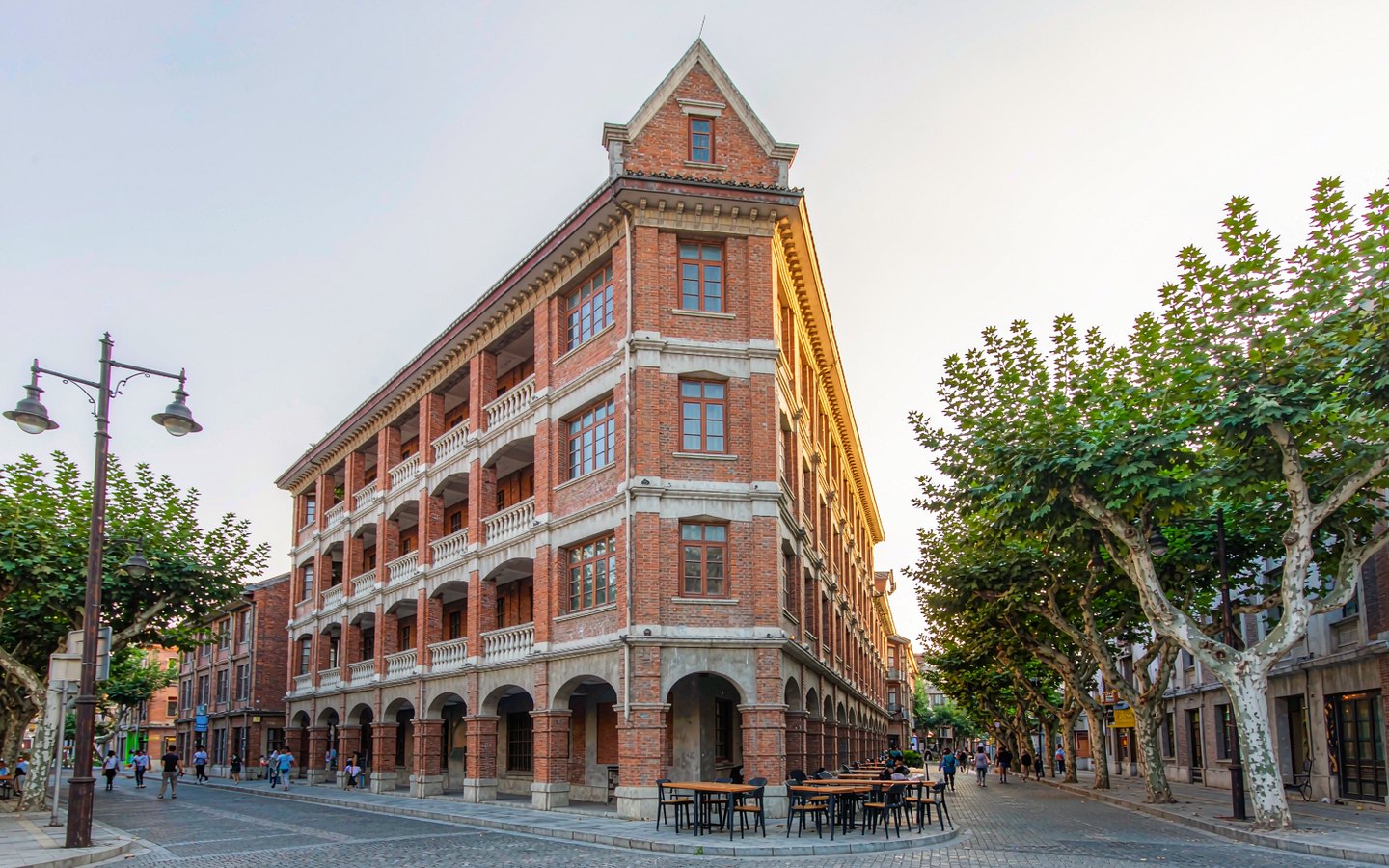Wedge-shaped red-brick Russian-era apartment building on an old street
