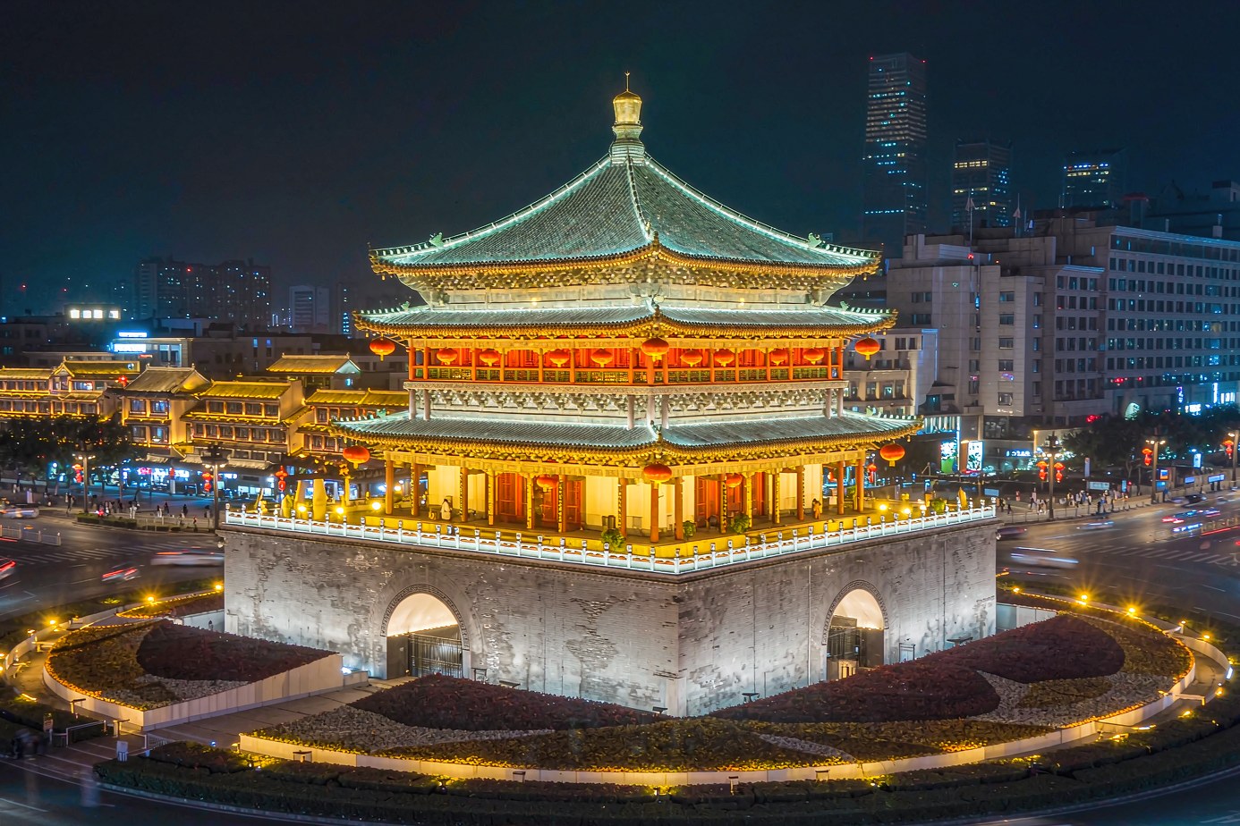 Xian Bell Tower illuminated at night above the roundabout