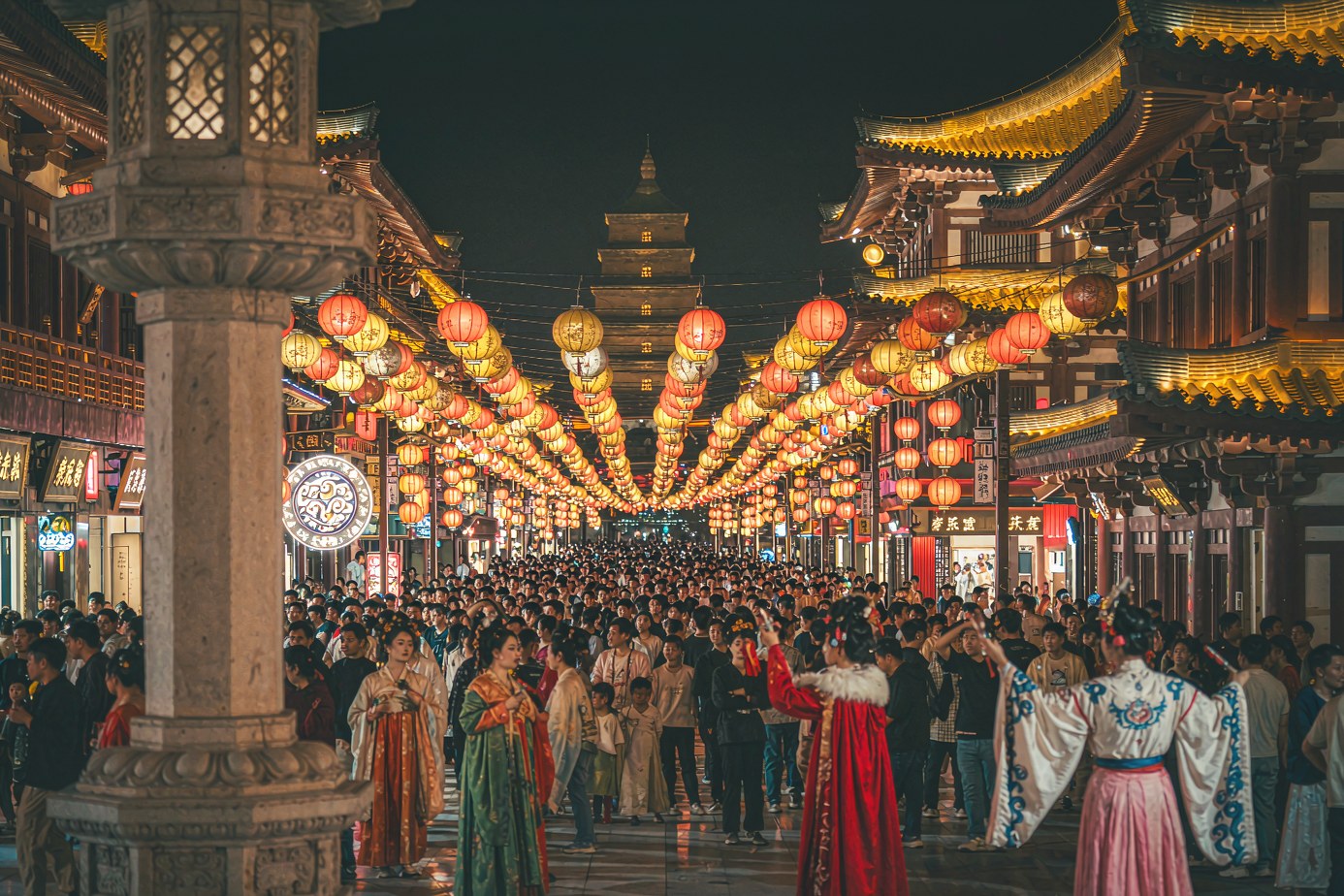 Tang Everbright City at night under a canopy of lanterns, the pagoda in the distance