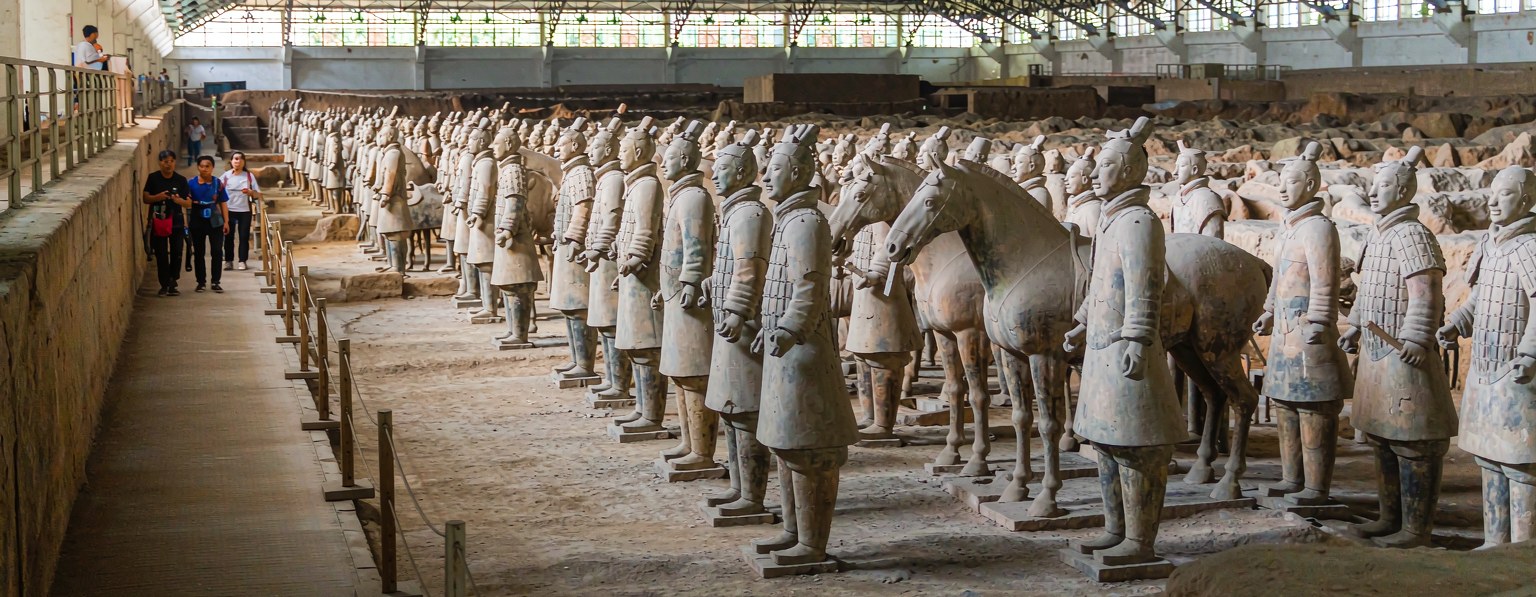 Life-size Terracotta Army warriors and a horse in the excavation pit near Xian