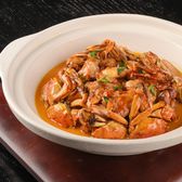 Savor this flavorful crab dish served in a white ceramic bowl, perfect for seafood lovers.