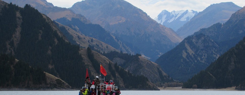 A tour boat crossing Heavenly Lake under the Tianshan peaks