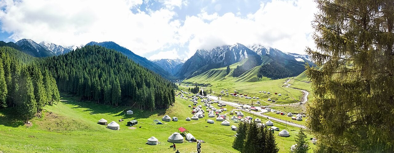 Yurts scattered across the green Nanshan pasture valley